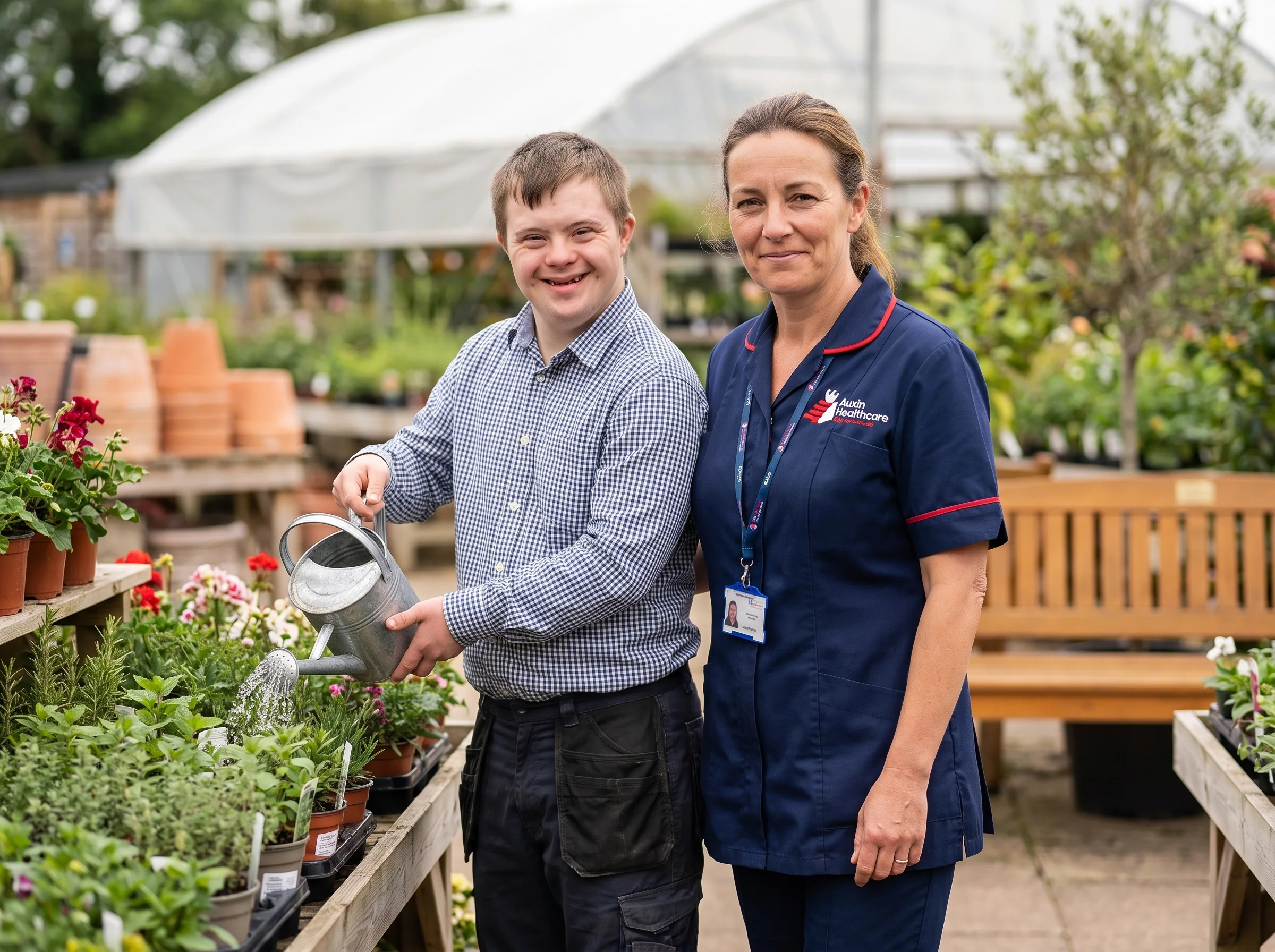 Young man with a learning disability volunteering at a garden centre, supported by an Auxin support worker in Lincolnshire