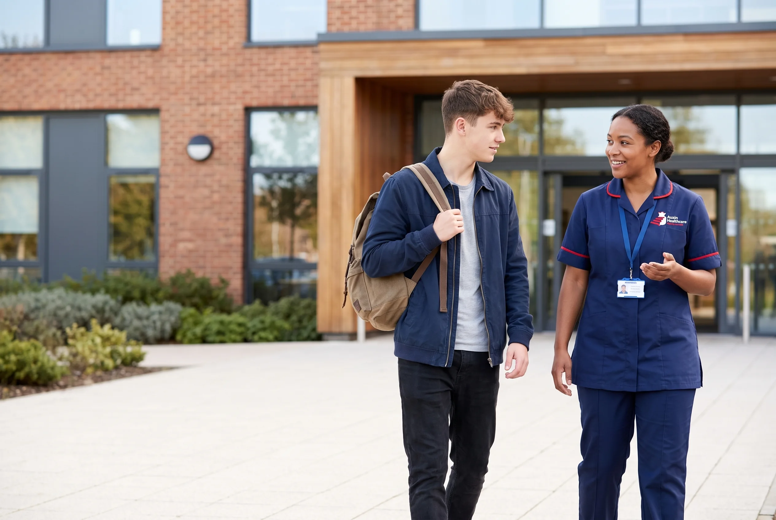 Auxin support worker walking with a young man on his first day at college as part of transition support in Lincolnshire
